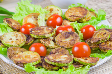 baked vegetable marrows with tomatoes and green sheet lettuce