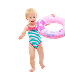 Baby in swimsuit playing with inflatable ring