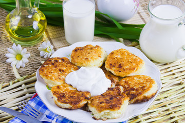 fried curd pancakes on a dish and milk