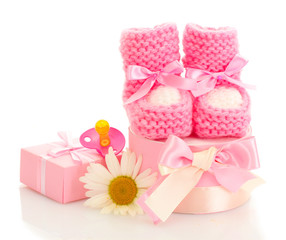 pink baby boots, pacifier, gifts and flower isolated on white