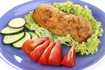 Tasty meat cutlet with garnish on plate close-up