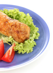 Tasty meat cutlet with garnish on plate isolated on white