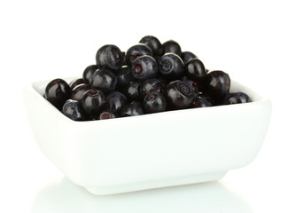 ripe blueberries in white bowl isolated on white
