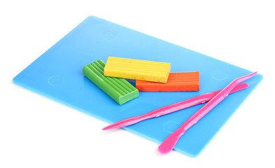 Fototapeta premium Children bright plasticine on desk with stacks isolated on