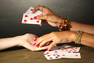 reading the lines hand in a woman's hands on grey backcground