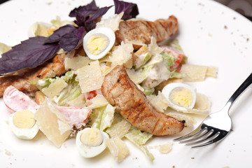 Caesar salad on white plate