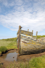 Remains of fishing boat on Norfolk coast at Blakeney