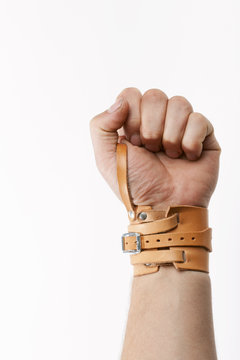 Male wrist bound with leather bandage
