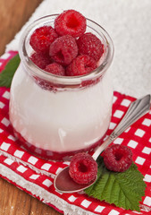Fresh Yogurt in a jar with Raspberries, leaves