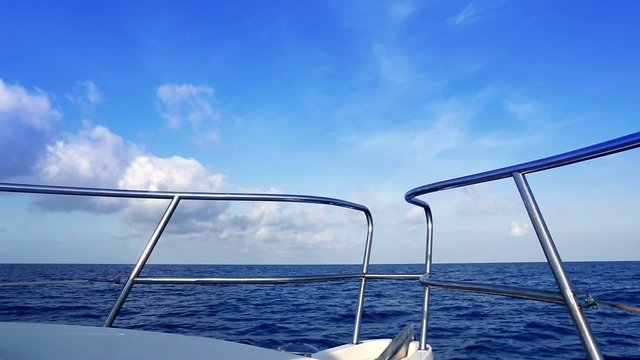 Boating in blue ocean sea view from boat bow deck