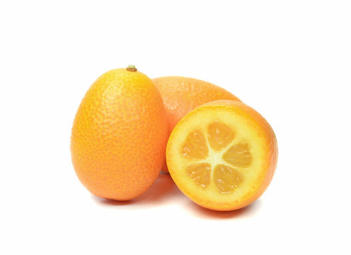 Group of sliced and whole kumquats on white background