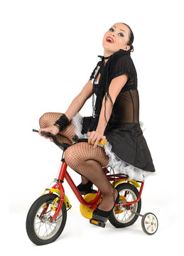 Beautiful french maid, at the children's bicycle