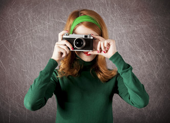American redhead girl with camera.