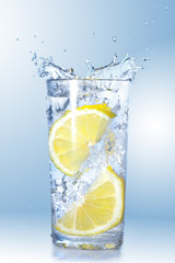 Fototapeta na wymiar two lemons fell in a glass
