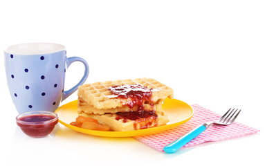 Tasty waffles with jam on plate isolated on white