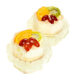sweet cakes with fruits isolated on white