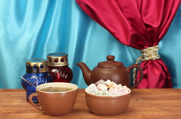 Teapot with cup and saucer with  sweet turkish delight
