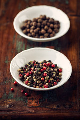 Different types of peppercorns and allspice berries