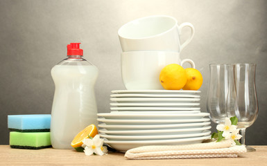 empty clean plates, glasses and cups with dishwashing liquid,