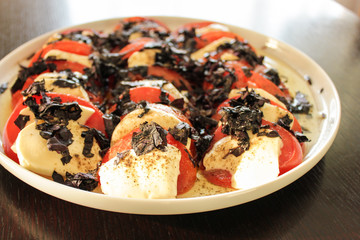 Sliced tomato with mozzarella and basil