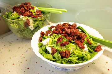Two bowls of salad on a table