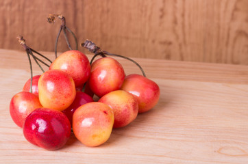 Fresh ripe cherries on wooden table