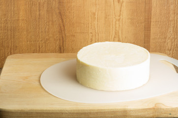 Round block of white cheddar cheese