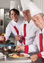 group of young beautiful professional chefs portrait in industri
