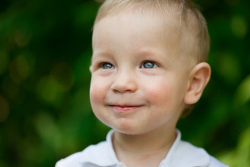 Child in white t-shirt outside