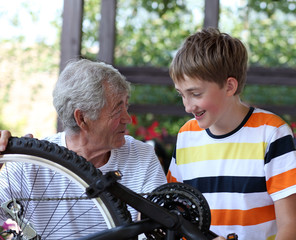 Grandfather and grandson of a bicycle repair