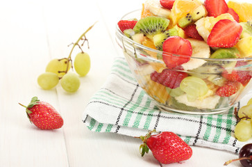 glass bowl with  fresh fruits salad and berries