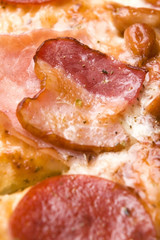 Italian pizza with bacon, salami and mozzarella cheese