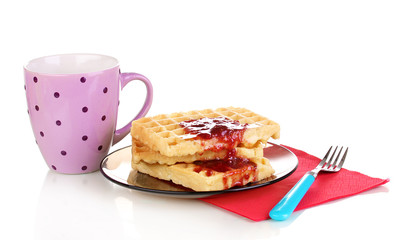 Tasty waffles with jam on plate isolated on white