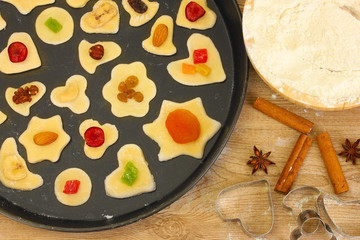 unbaked cookies with candied fruits and nuts in a pan close-up
