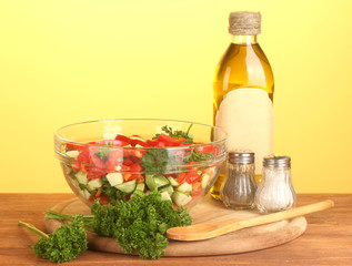Fresh salad and oil on green background