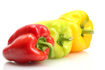 fresh yellow, red and green bell peppers isolated on white