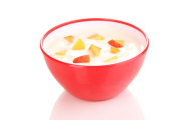Yoghurt with peach in bowl isolated on white