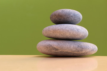 Three stones on a green background - harmony, stability