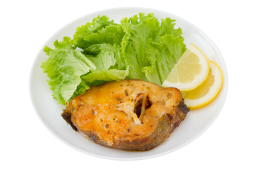 fish with salad and lemon on the white plate