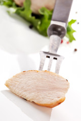 Juicy chicken on fork.