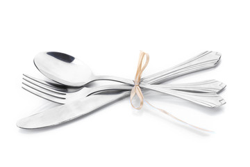 Silver fork, spoon and knife tied with ribbon isolated on white