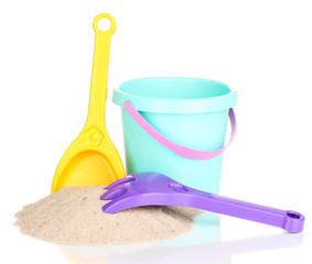 Children's beach toys and sand isolated on white