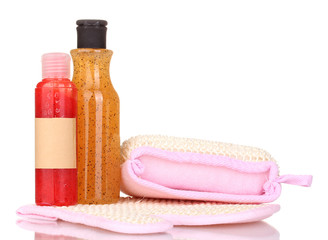 Bottles with scrub and sponges isolated on white