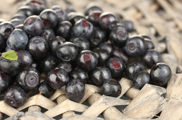Fresh blueberries on wicker mat close-up