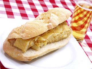 Spanish omelet sandwich with beer.