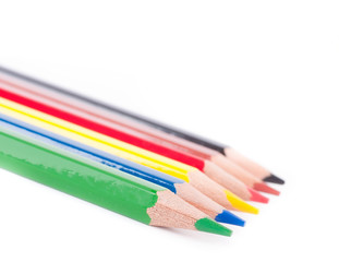 Crayons on a white background, school belongings