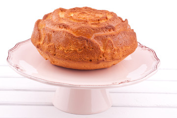 vanilla cake on a stand on a white background