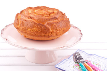 vanilla cake on a stand on a white background
