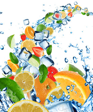 Fresh citruses in water splash with ice cubes