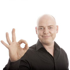 bald man sign perfect and smiling